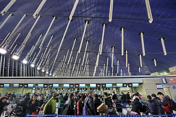 2016年2月2日晚,旅客在上海浦东机场排队办理乘机手续.资料图